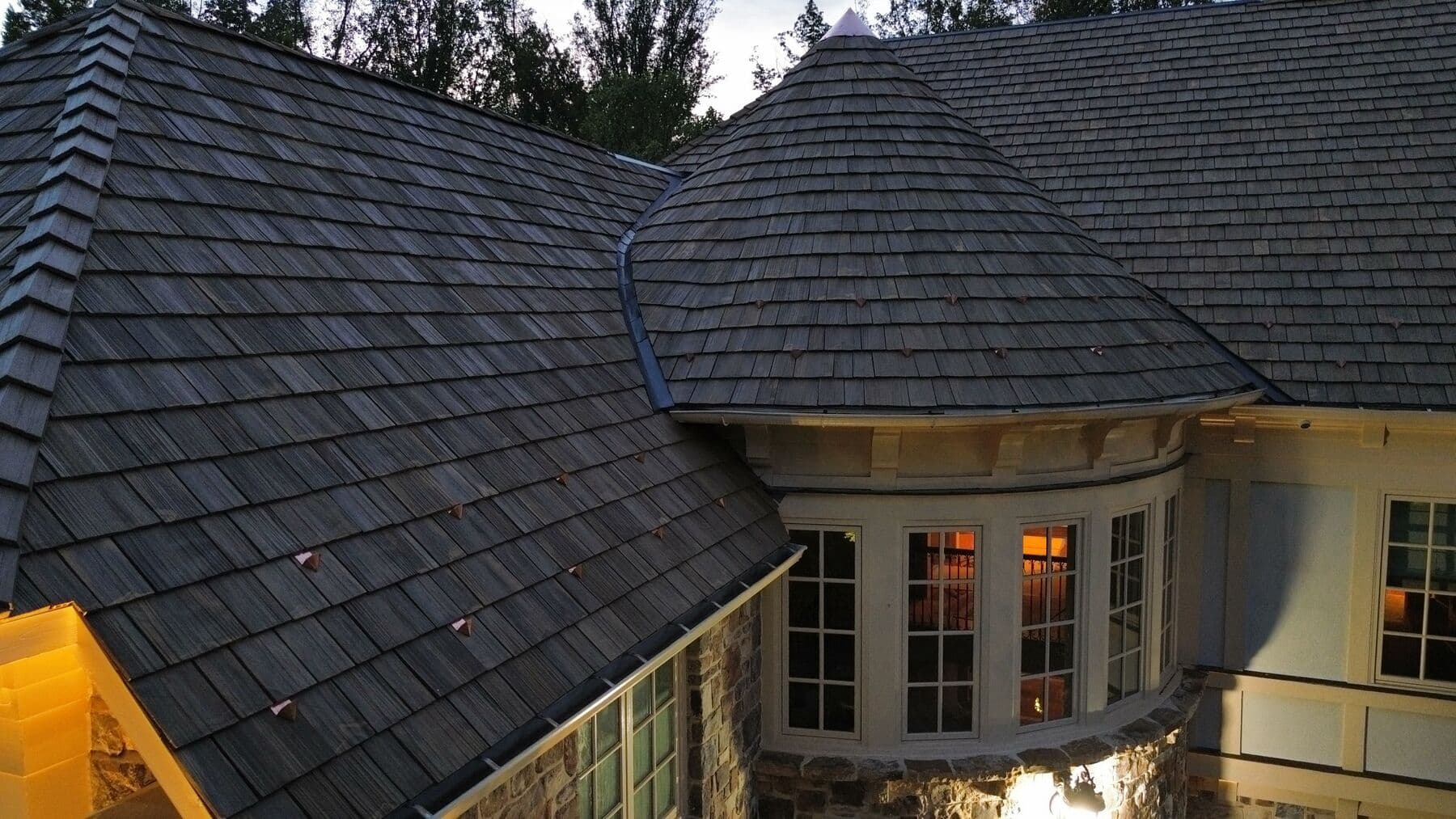 Close-up of a rounded turret in Brava synthetic shake with copper accents