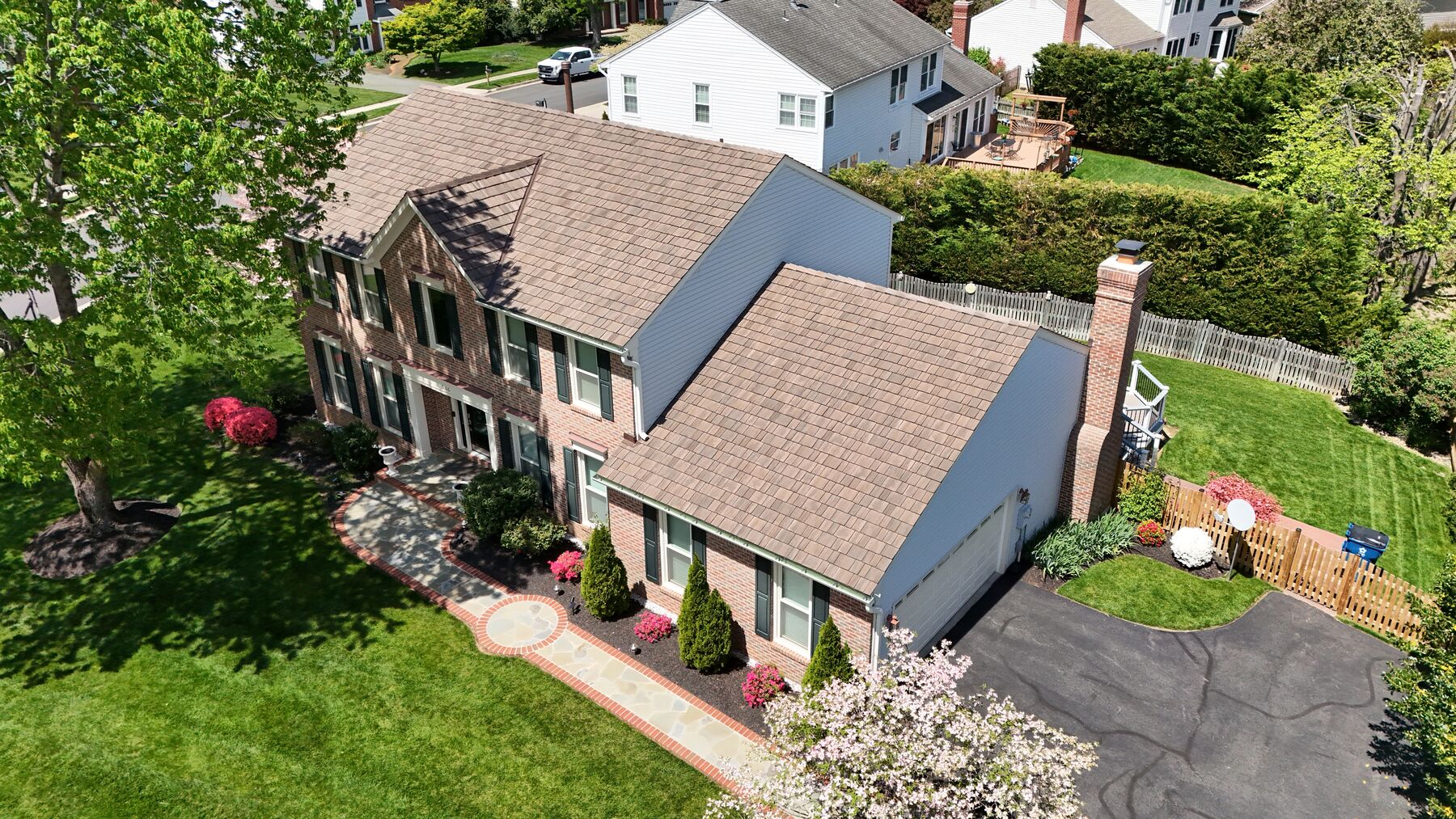Brick colonial home with a new Brava synthetic shake roof