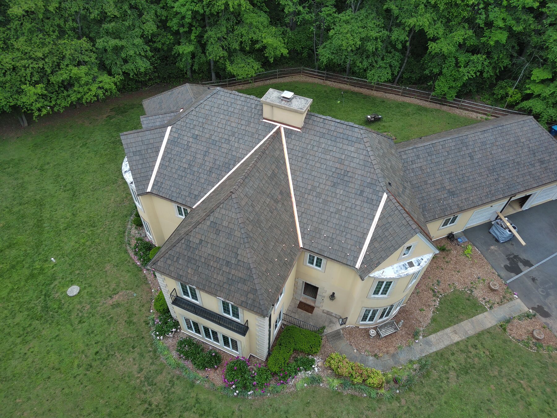 Aerial view of a completed Brava synthetic shake roof on a stucco home