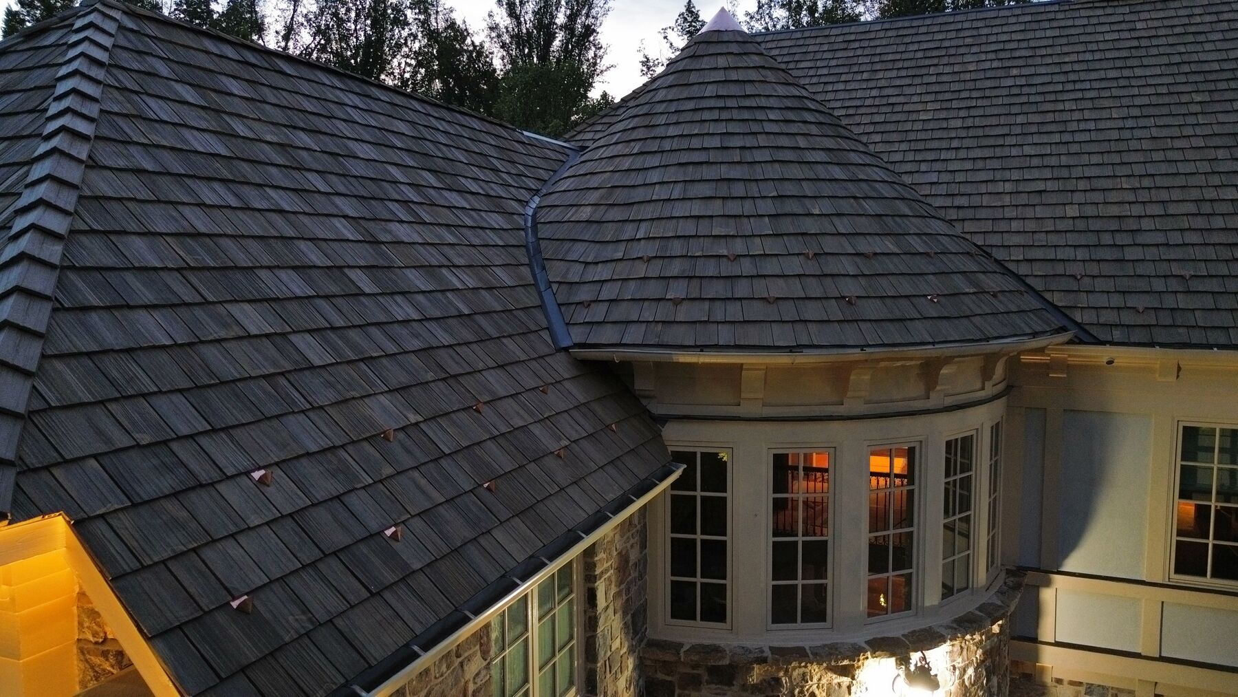 Close-up of a rounded turret in Brava synthetic shake with copper accents