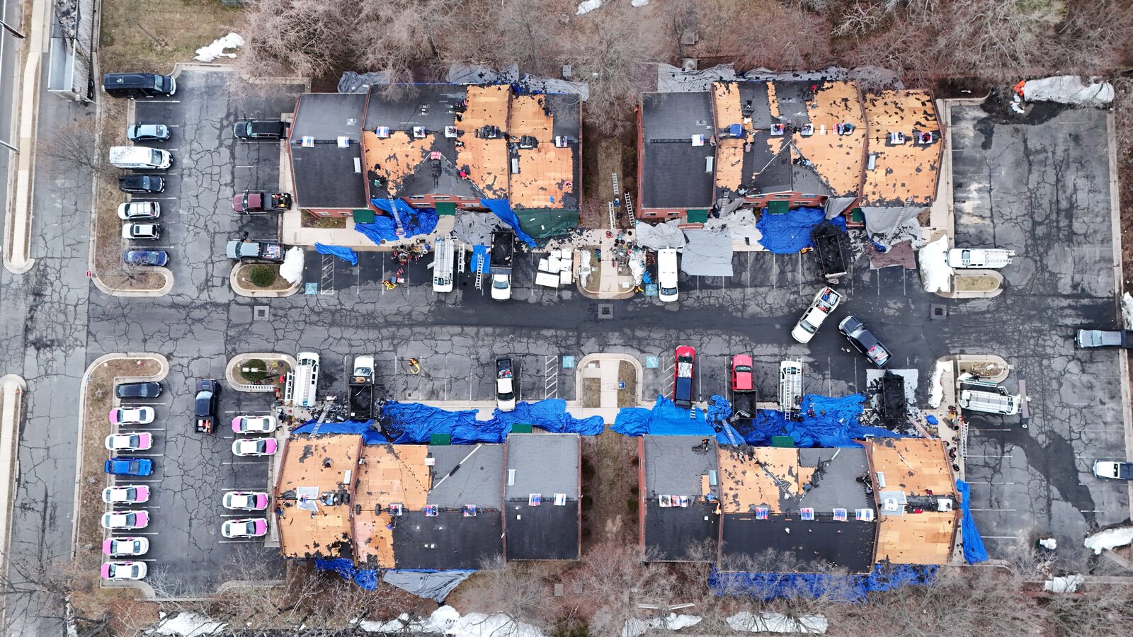 Top-down aerial of a large townhome community mid tear-off