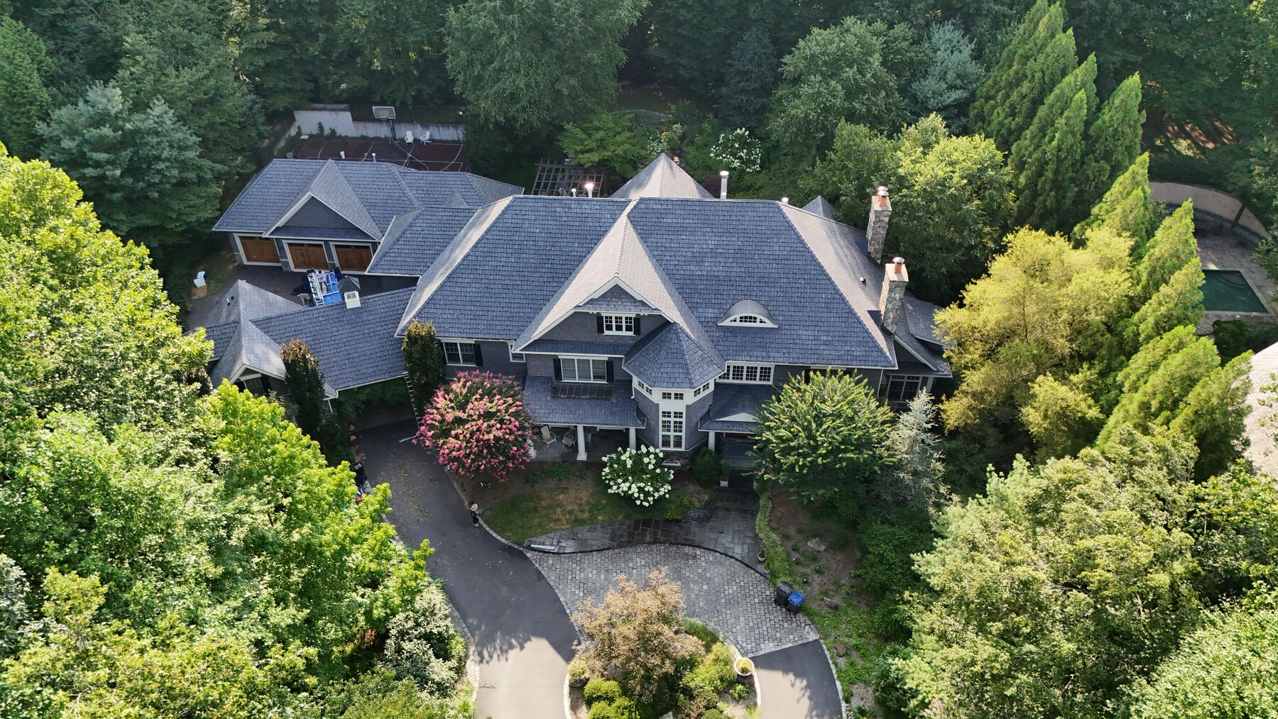 Shingle-style estate home with synthetic slate roof