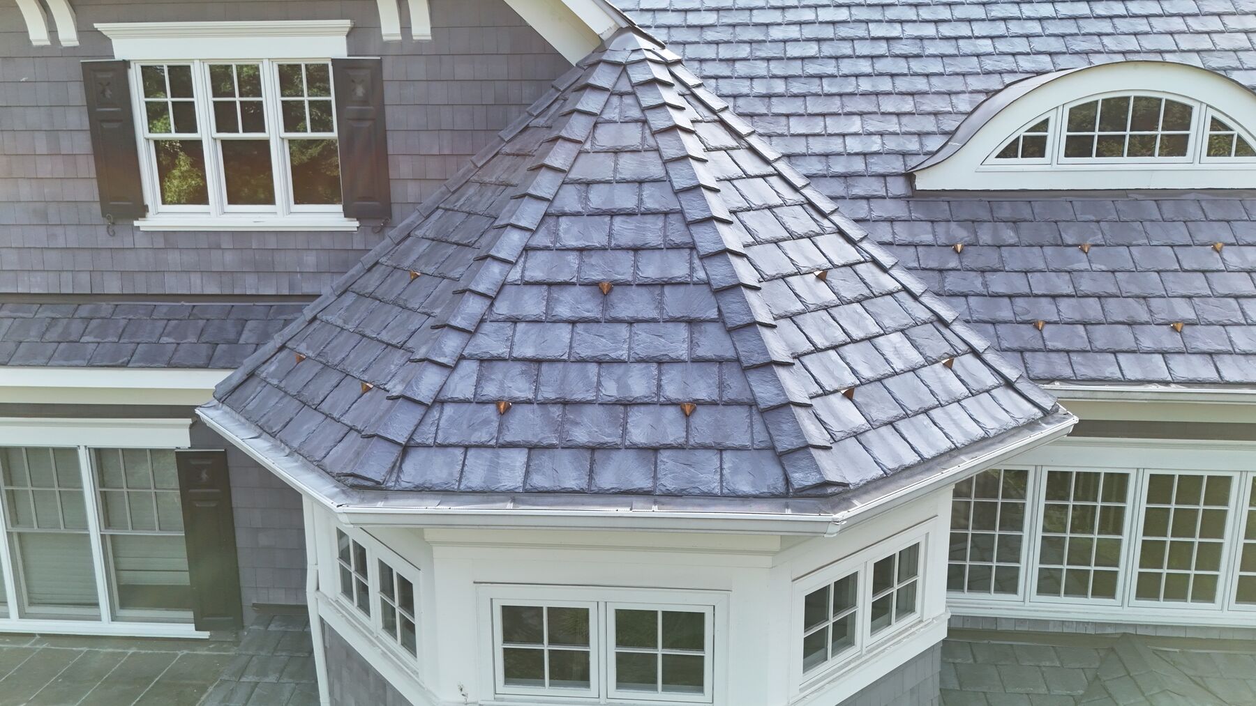 Synthetic slate turret with copper snow guards